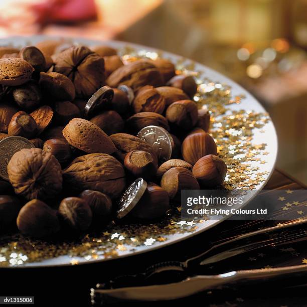 variety of nuts on a plate at christmas - variety fotografías e imágenes de stock