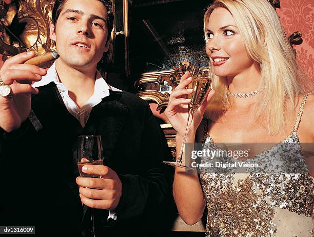 couple drinking champagne and smoking a cigar - beautiful women smoking cigars fotografías e imágenes de stock