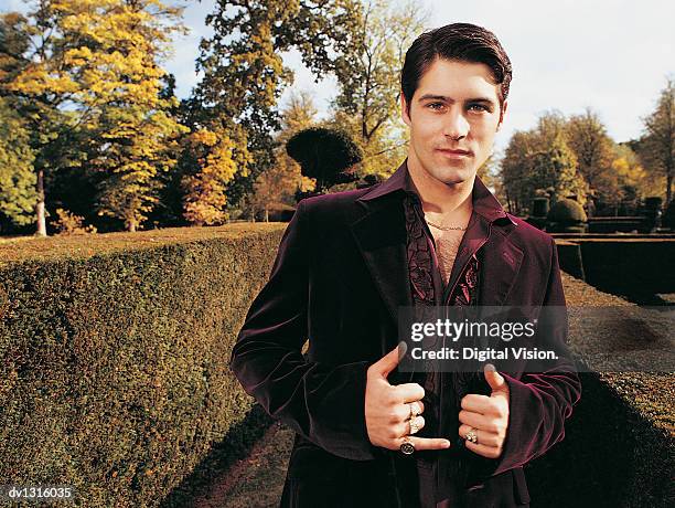 portrait of a wealthy young man standing in a garden - status symbol stock pictures, royalty-free photos & images