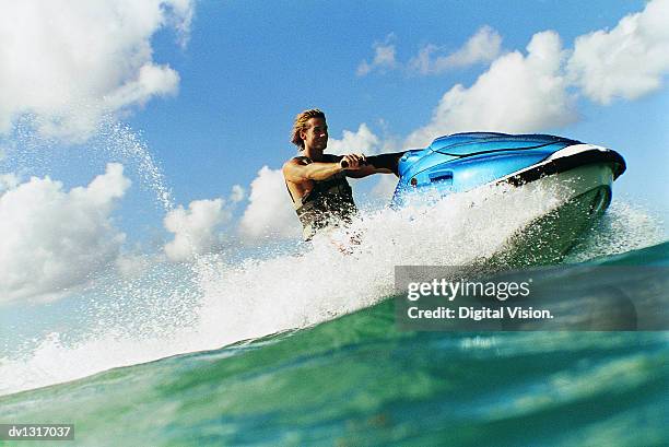 man riding a jet ski - jet ski ストックフォトと画像