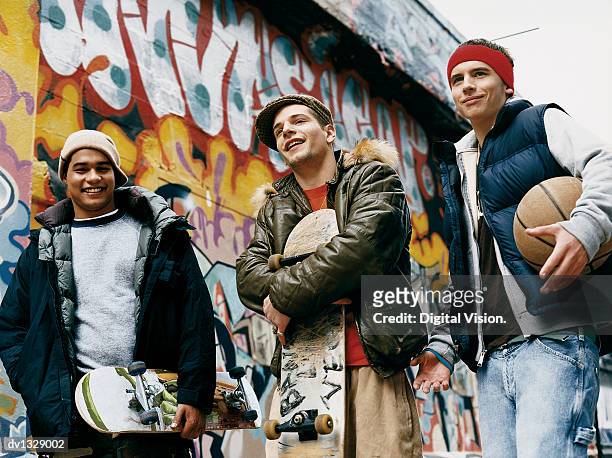 teenage boys standing in an urban backstreet holding skateboards and a basketball - lexus cup of china 2014 isu grand prix of figure skating day 3 stockfoto's en -beelden
