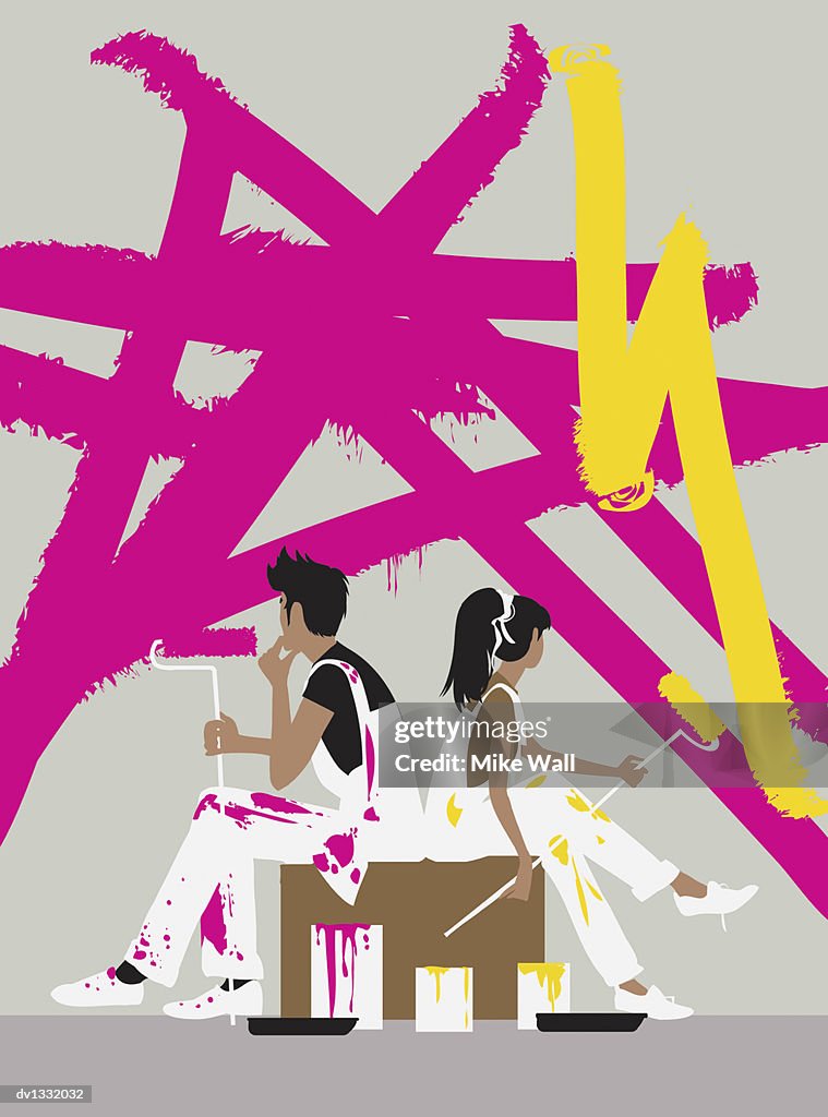 Young Couple Sitting With Paint Rollers Considering Choice of Decorating Colours