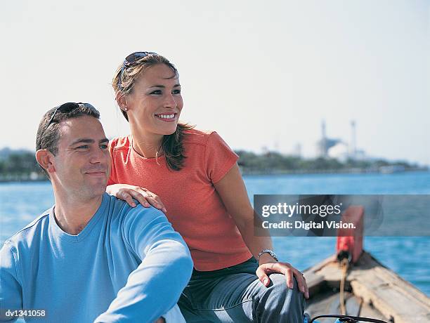 couple sitting on a boat enjoying a journey across the dubai creek, dubai - the journey stock pictures, royalty-free photos & images