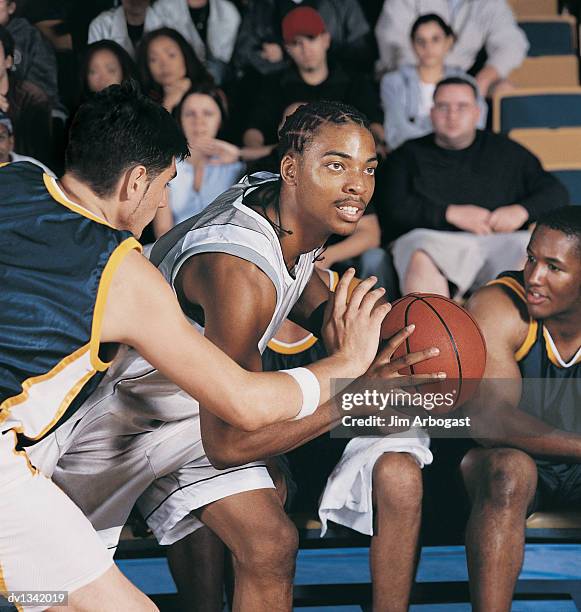 basketball player attacking a defender in a basketball court - anfallsspel bildbanksfoton och bilder