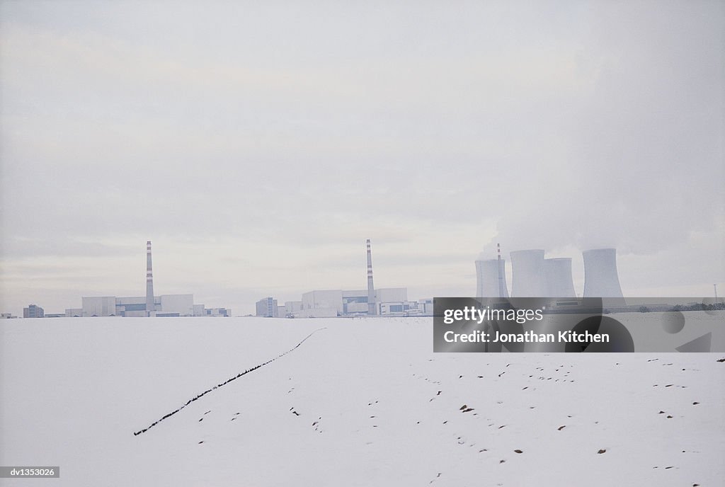 Distant Power Station in Winter With Cooling Towers