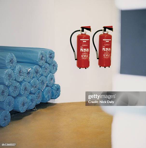 two fire extinguishers hanging from a wall - emergency equipment 個照片及圖片檔