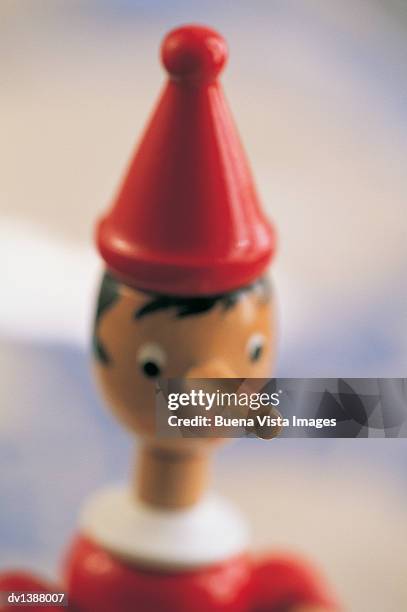 toy figurine of pinocchio - pinocchio stock-fotos und bilder