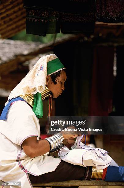 padaung woman sewing cotton, mae hong son, thailand - padaung stock pictures, royalty-free photos & images