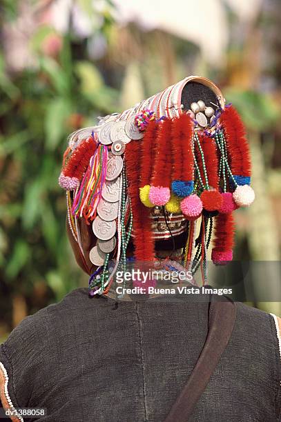 rear view of an akha woman wearing an ornamental headdress, chiang rai, thailand - hill tribes stock pictures, royalty-free photos & images