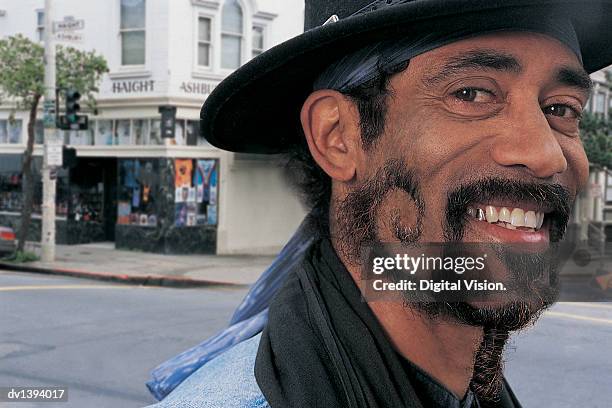 man with funky beard in haight-ashbury, san francisco - capped tooth stock-fotos und bilder