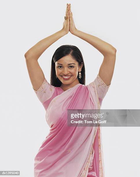 studio portrait of a woman in a sari dancing with her hands together - sari isolated stock pictures, royalty-free photos & images