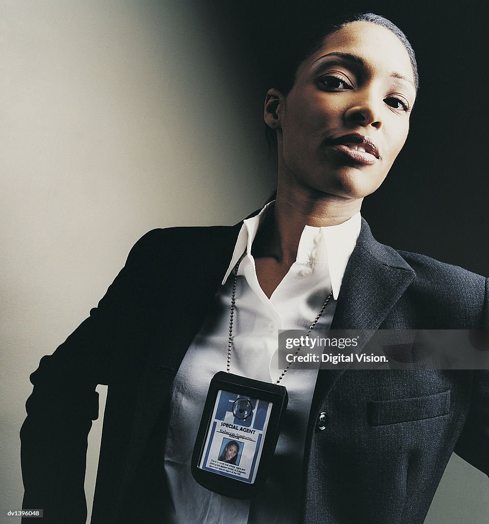 Studio Portrait of a Female Special Agent With an ID Card