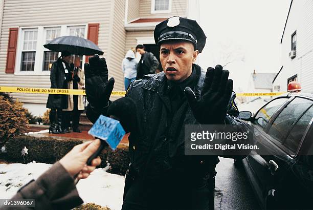 police officer holds reporter back as a person is arrested in their home - group of bipartisan house reps announce russian sanctions legislation stockfoto's en -beelden