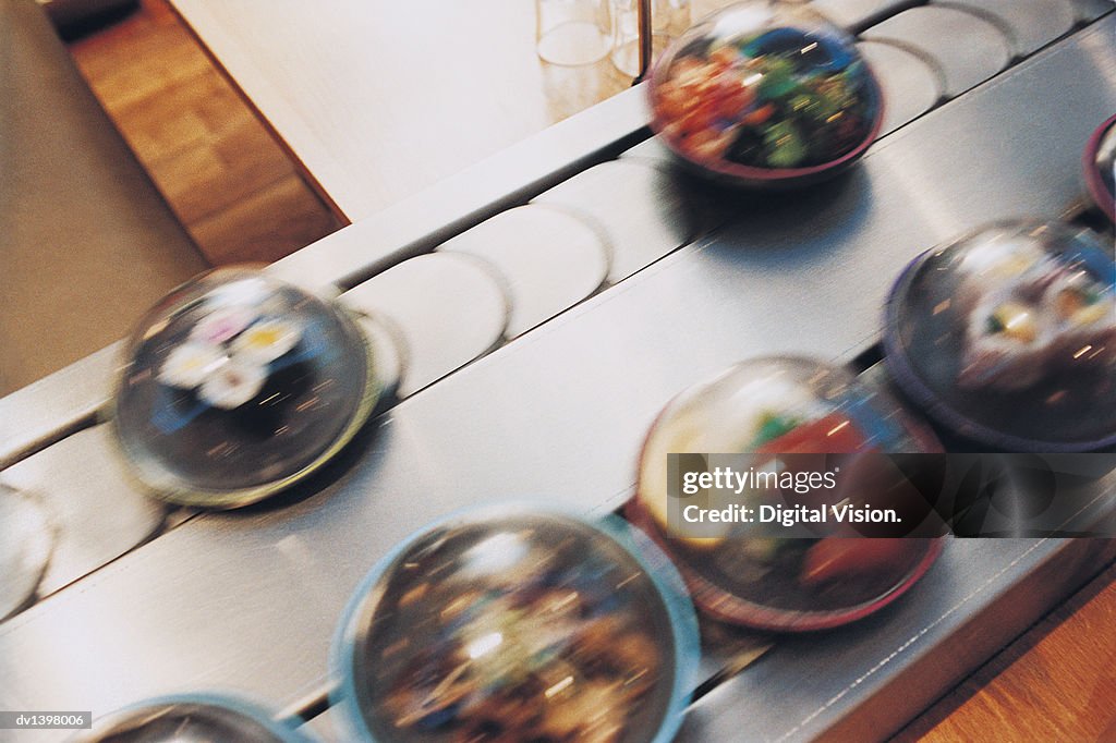 Above View of Sushi Meals in Containers on a Conveyor Belt