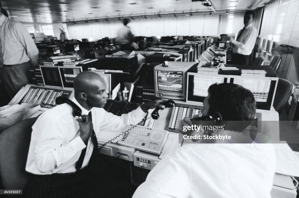 Stock brokers working at stock exchange