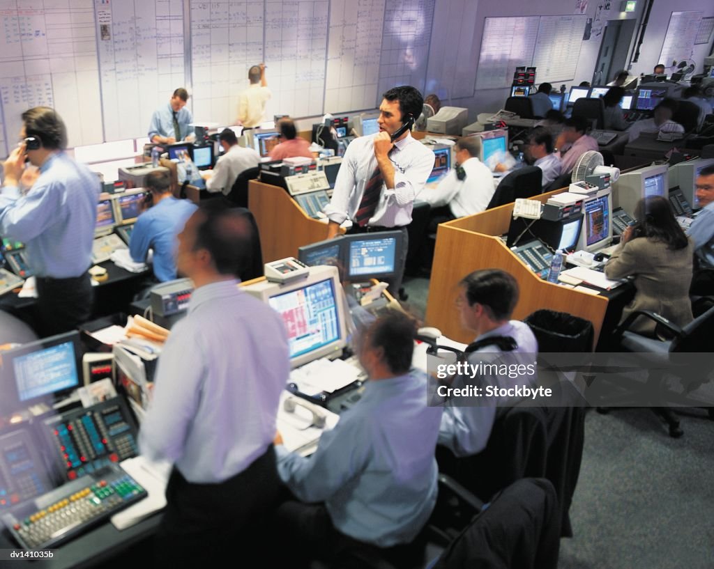 Stock brokers working at stock exchange