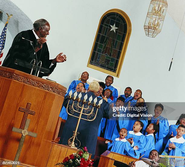 gospel choir singing and clapping during a church service - música gospel fotografías e imágenes de stock