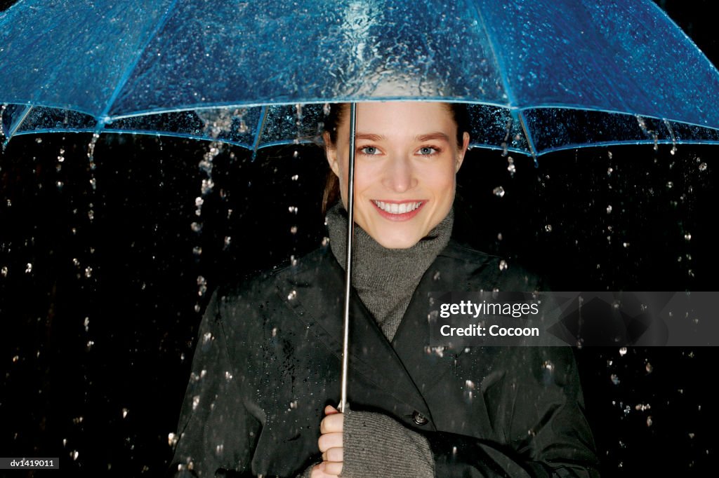 Portrait of a Woman Sheltering Under an Umbrella