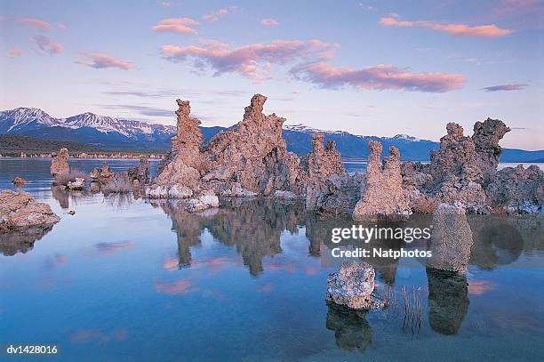 tufa rock formations with a mountain range in the background, mono lake, california, usa - tufa stock pictures, royalty-free photos & images