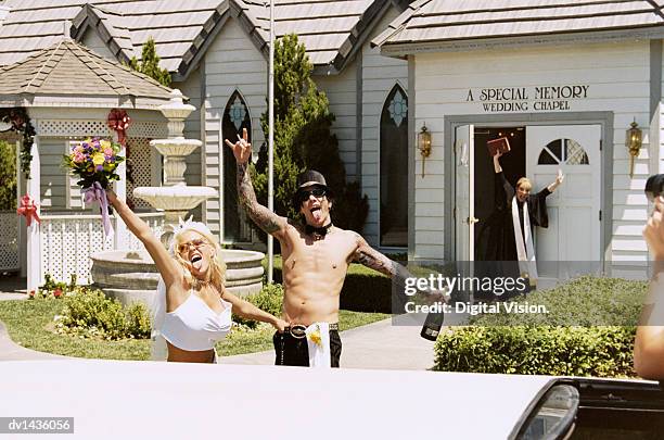 young newlywed couple standing outside a church - wedding limo stock pictures, royalty-free photos & images