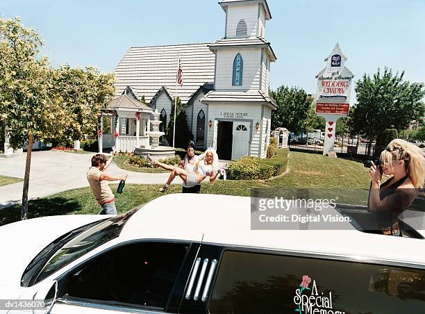 newlywed couple coming out of a chapel and friends with a limousine, nevada, usa - vegas wedding stock pictures, royalty-free photos & images