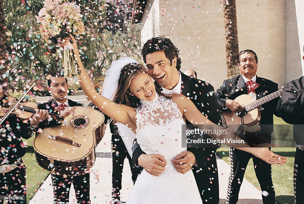 Bride and Groom Celebrating With Confetti and a Mariachi Band