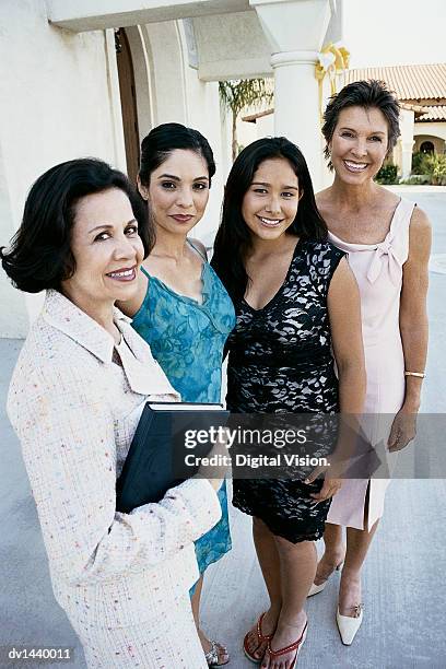 portrait of four well dressed women standing outside a church - godsdienstvrijheid stockfoto's en -beelden