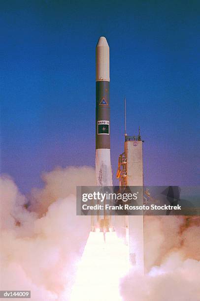 nato satellite lifting off from launch pad - rockets stock pictures, royalty-free photos & images