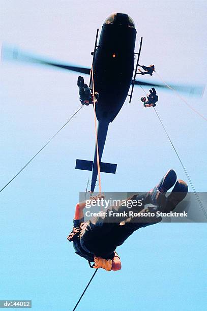 infantryman rappelling from uh-1 iroquois helicopter - huey helicopter stock pictures, royalty-free photos & images
