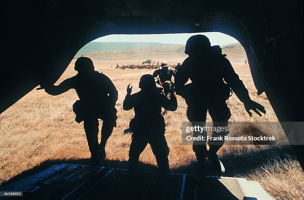 Soldiers boarding CH-47 Chinook Helicopter in training exercise
