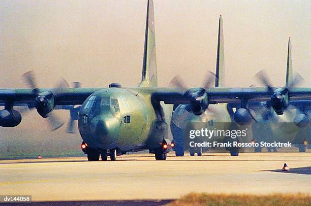 carrier planes lined up on runway - taxiing stock pictures, royalty-free photos & images