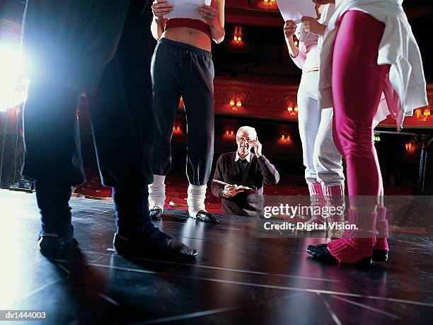 theatre director looking up at dancers rehearsing on stage - director of natl geospatial intelligence agency testifies at senate hearing stockfoto's en -beelden