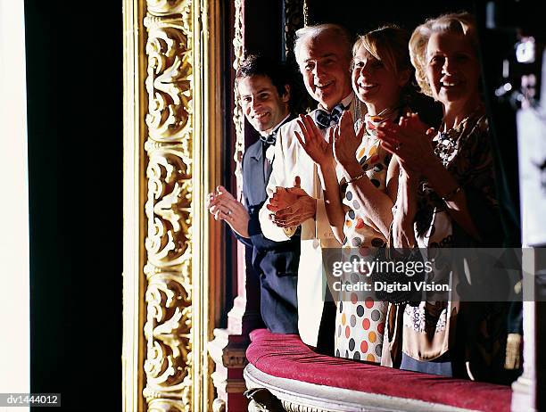 mature and young couples standing in a theatre balcony applauding - stående ovation bildbanksfoton och bilder