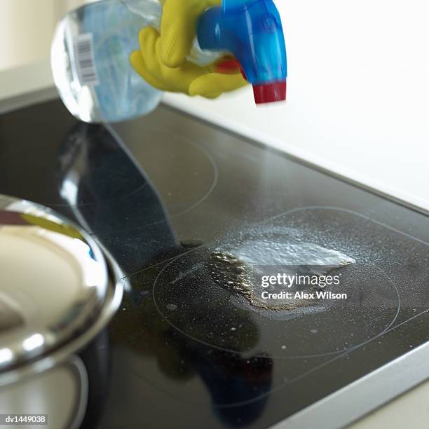 hand aiming a spray-gun to clean a hob - dirty pan stock pictures, royalty-free photos & images