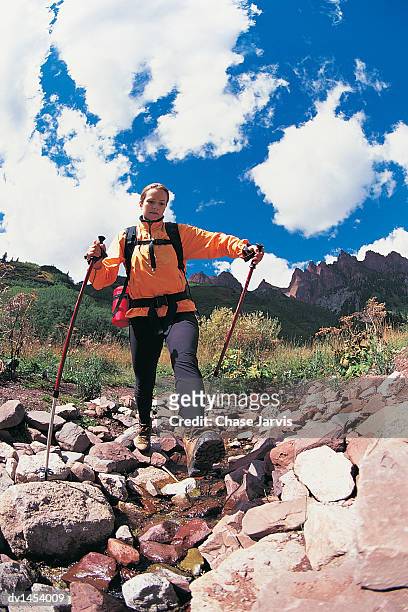 female mountain walker walking across rocks, colorado, usa - jarvis summers stock pictures, royalty-free photos & images