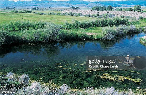 man fishing from a boat on a river, montana, usa - jarvis summers stock pictures, royalty-free photos & images