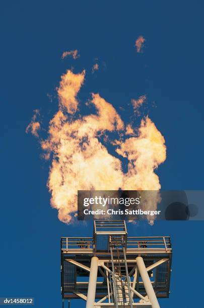 flame burning from an oil rig - chris sattlberger stock pictures, royalty-free photos & images