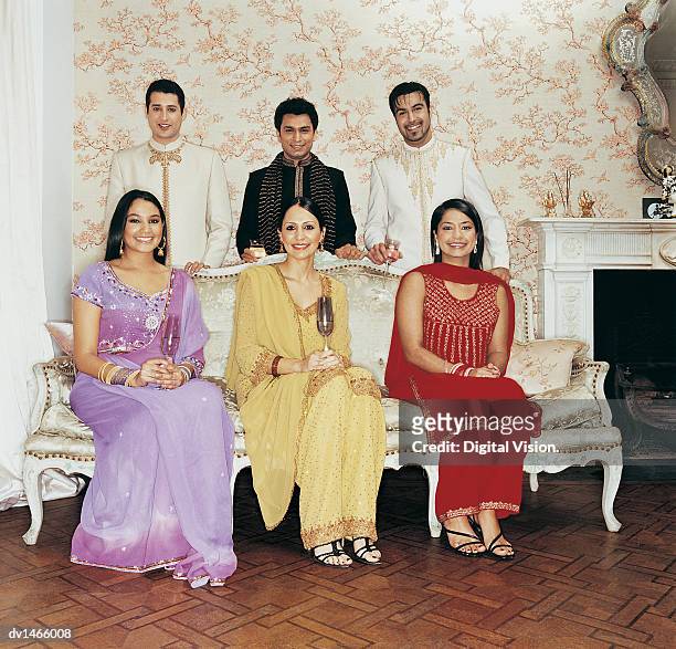 portrait of six young adults by an ornate sofa - ornate house furniture stock-fotos und bilder
