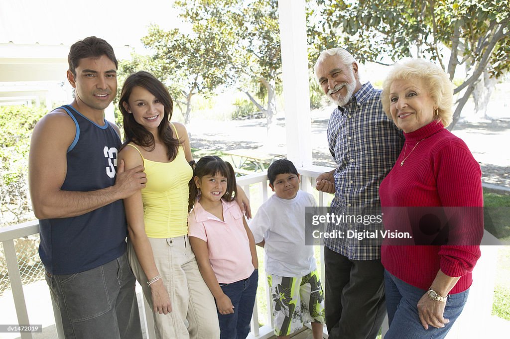 Three Generational Family Standing on a Veranda Together