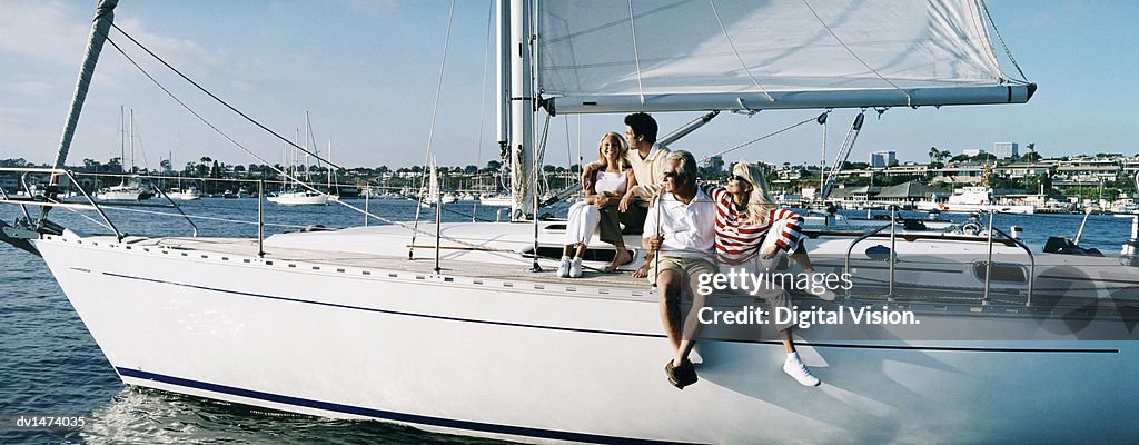 Family Couples Sitting on the Deck of a Sailing Yacht