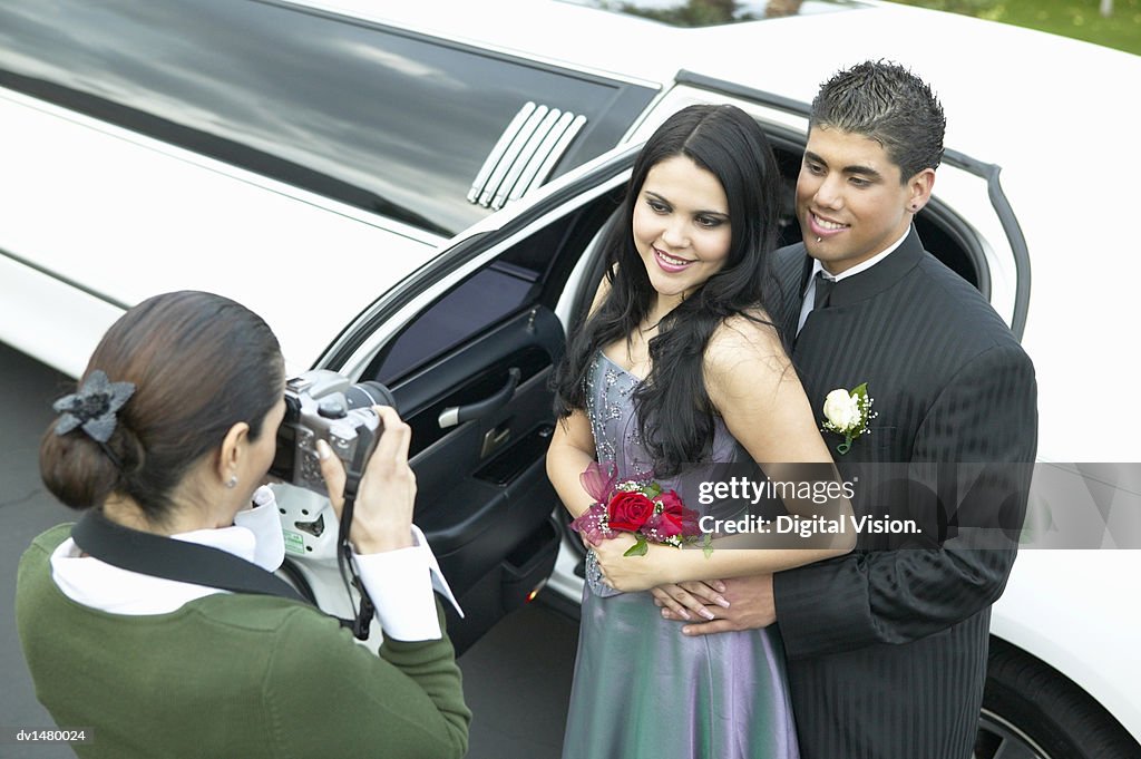 Mother Photographing Couple Departing for Their High School Prom