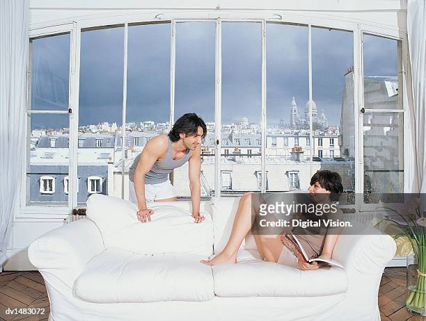 couple in living area of apartment with views of sacre coeur and montmartre - coeur fotografías e imágenes de stock