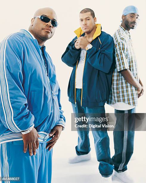 three young men with attitude wearing casual clothing - tracksuit stock pictures, royalty-free photos & images