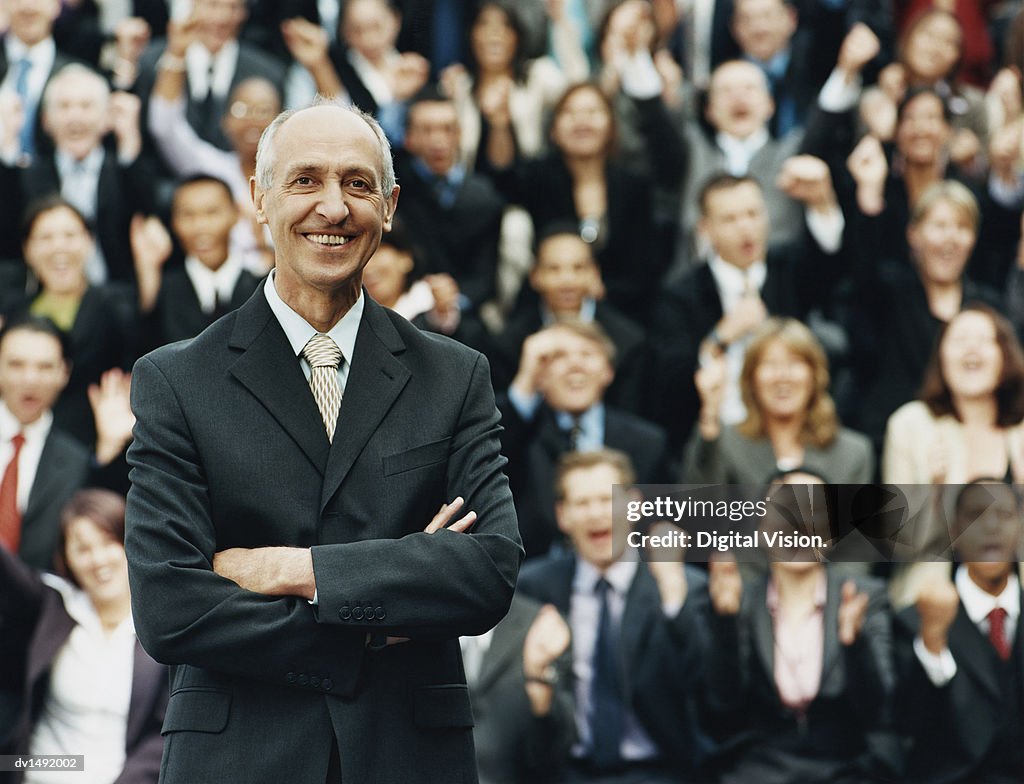 Male CEO Standing in Front of a Large Group of Business People