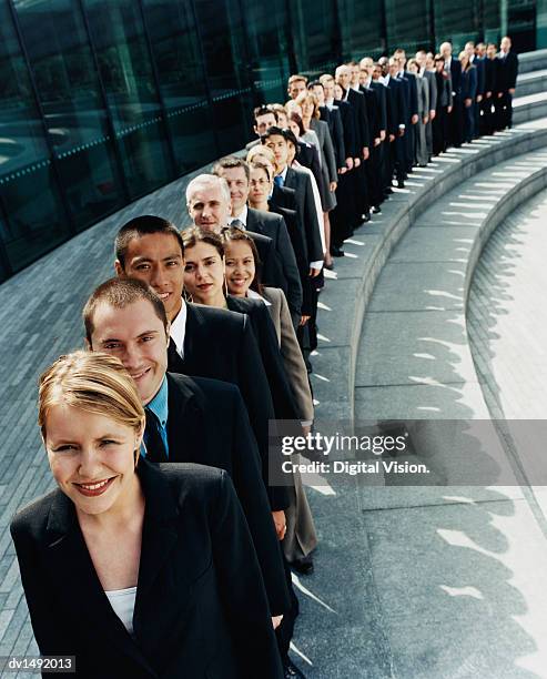 line of business people waiting outdoors on a step - gente en fila fotografías e imágenes de stock