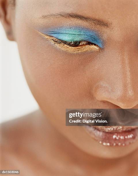 smiling, young woman holding a toothbrush close to her mouth - colorful eye liner stock pictures, royalty-free photos & images