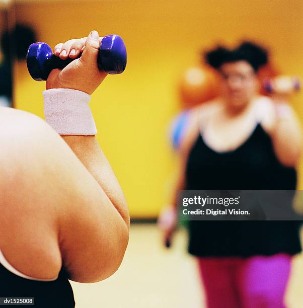 close up detail of a woman doing weight training in a gym - weight training foto e immagini stock