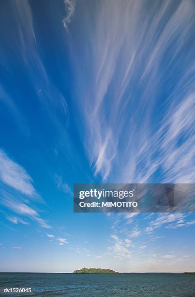 high section view of clouds in the sky above an isolated island in the sea, shelikof straight, alaska, usa - island in the sky stock pictures, royalty-free photos & images