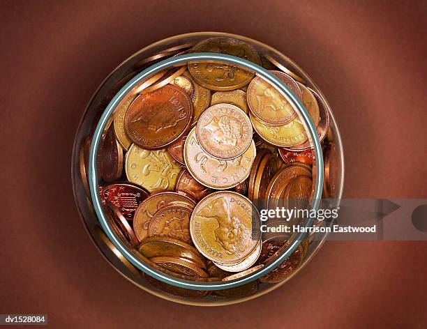 one and two pence copins in a glass jar, viewed from directly above - tvåpencemynt bildbanksfoton och bilder