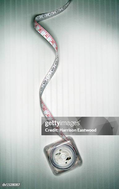 unfurled tape measure on a white background - metric system stock pictures, royalty-free photos & images